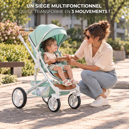 Poussette 3 en 1 Essentielle Amande vert d'eau en mode assise, enfant assis face à sa maman accroupie dans un parc