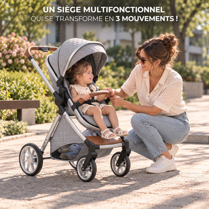 Poussette 3 en 1 Essentielle Granit gris clair en mode assise, enfant assis face à sa maman accroupie dans un parc